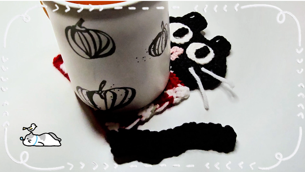 A playful cat coaster ready for coffee time
